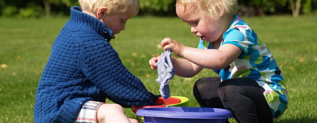 children playing with toys in the grass